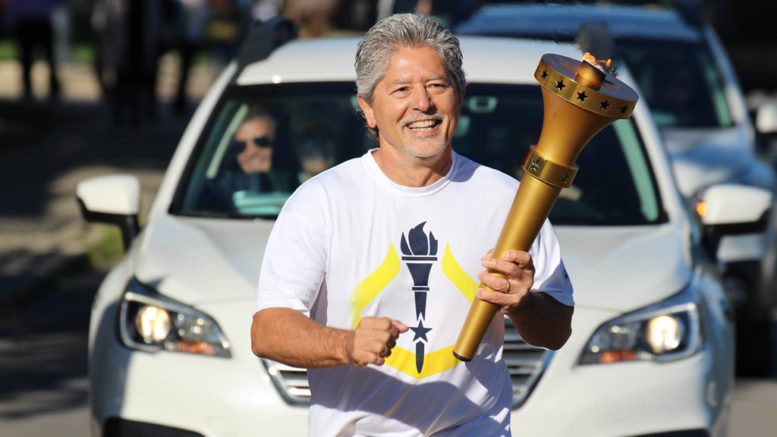 Indiana Bicentennial Torch Relay in Delaware County. Jeff Bird carries the torch. Photo by: Sadie Lebo