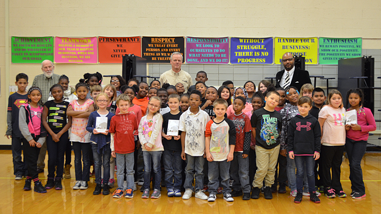 Kiwanis Club members and students are pictured with their new dictionaries. Photo provided.