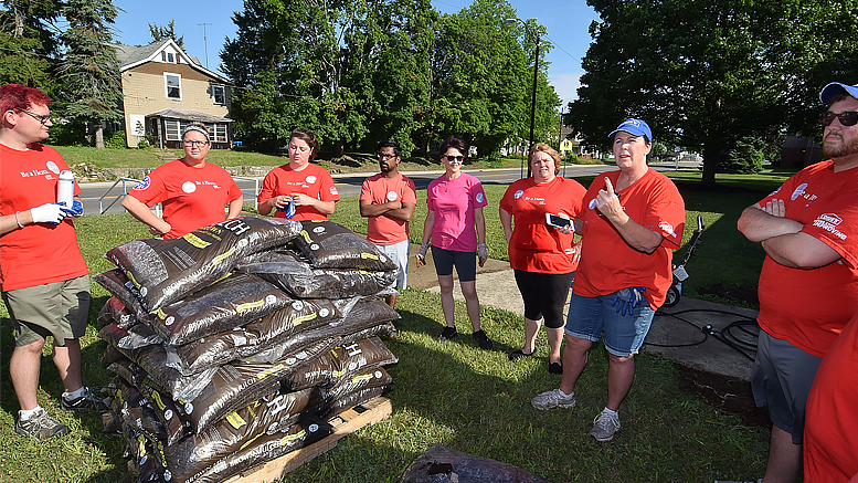 Volunteers from Lowe's have a brief meeting before starting their work on June 22nd at the Boys & Girls Club of Muncie. Photo by: Mike Rhodes