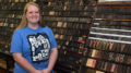 Kim Miller, owner of Tribune Showprint, is pictured in front of the "type wall" inside her shop at MadJax. Photo by: Mike Rhodes