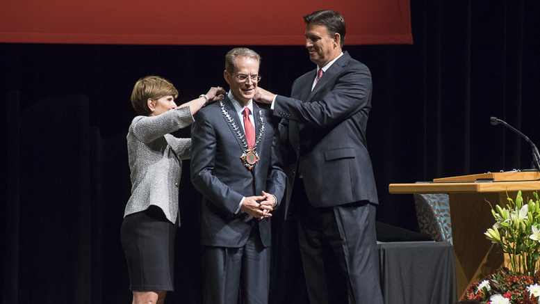 Renae Conley (L) Vice Chair, Board of Trustees and Richard Hall (R), Chair, Board of Trustees present the University Medallion to Geoffrey S. Mearns,(C) Ball State's 17th President. Photo by: Mike Rhodes