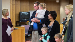 A family adoption is finalized on November 17th in the Delaware County Justice Center. Photo by: Jeneca Zody
