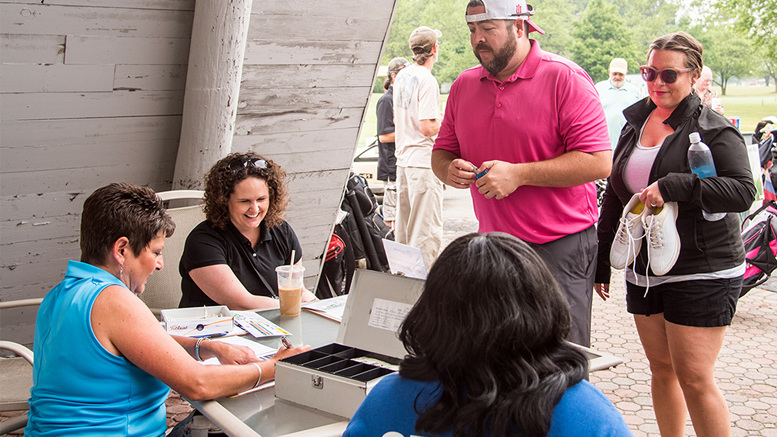 Golfers arrived early on June 10th to check in with Hollie Partin, Sara Shade, and Qiana Clemens. Photo provided.