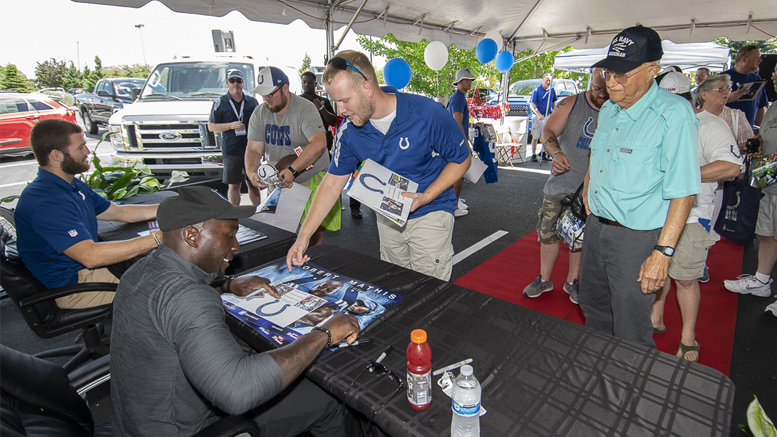 Jack Doyle and Robert Mathis sign autographs and give posters to fans at the Toyota and Kia of Muncie Tent Sale. Photo by: Mike Rhodes