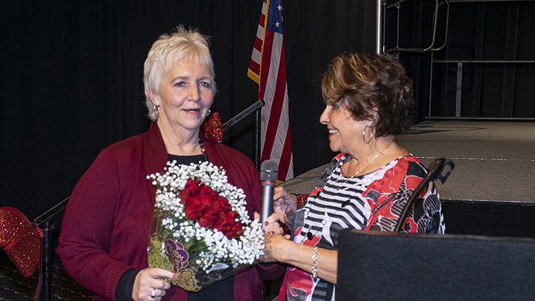 Pat Hart (L) executive director of the Delaware County Prevention Council is pictured receiving flowers from Carol Ammon (R), board vice president upon the announcement of Hart's retirement. Photo by: Mike Rhodes