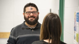 Paul Ward is pictured talking with an associate with an Ash Wednesday "smudge" appearing on his forehead. Learn what that means below. Photo by: Mike Rhodes