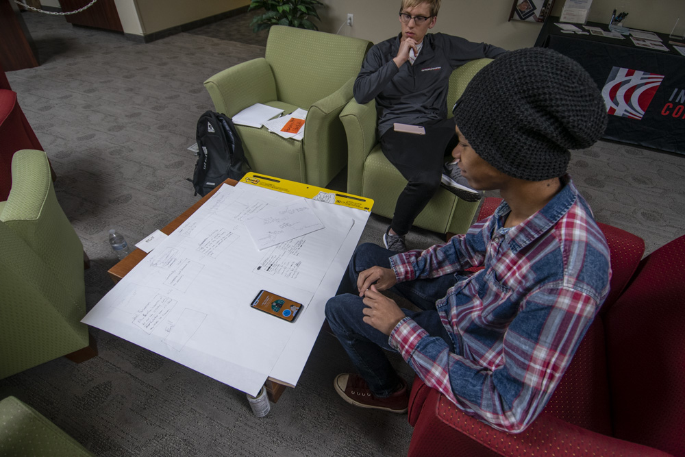 Aaron Best and Rashad J. Carter look over their plans for the Muncie Service Learning project. Photo by: Mike Rhodes