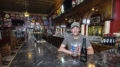 Chris Piche is pictured at the bar with a bottle of Rodenbach 2011 Vintage Flemish Red/Brown Sour Ale—one of the most unique beers made by Rodenbach. Photo by: Mike Rhodes