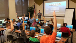 Ryan Hunter, co-founder of TechWise Academy, leads a Minecraft Party in which students get to learn about command blocks and play online in a safe environment. File photo