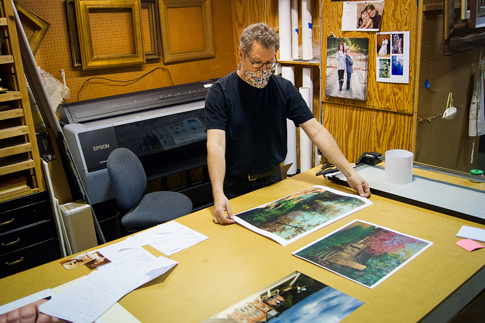 Carl Schafer examines a photographic enlargement made with the Epson large format photographic printer. Photo by Matt Howell.