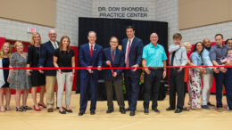 Dr. Don Shondell (center) cuts the ribbon to the 19,000-square-foot Dr. Don Shondell Practice Center on the Ball State University campus on July 18, 2018. Joining Dr. Shondell are family members, Ball State President Geoffrey S. Mearns, athletics director Beth Goetz, members of the Ball State Board of Trustees, current Ball State women’s volleyball head coach Kelli Miller Phillips, and former Ball State men’s volleyball coach Joel Walton. Photo provided by Ball State University.