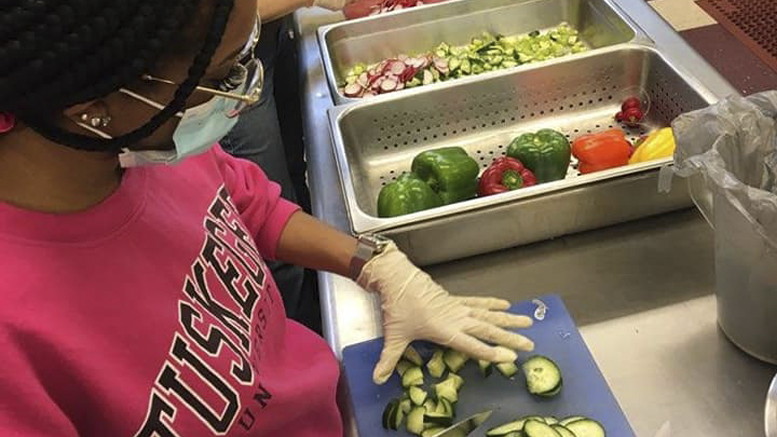 A volunteer is pictured preparing food at the Soup Kitchen of Muncie. Photo provided.