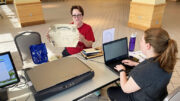 LeAnn Romine holds up her great-grandfather’s 1910 high school diploma while Alexis Robertson, Local History & Genealogy Specialist at Muncie Public Library, takes notes before digitizing the item at the first Community Scan Day held at Minnetrista. Photo by Sara McKinley, Muncie Public Library