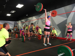 Female competitors performing WOD 1 Cluster ladder during Downtown Throwdown II.