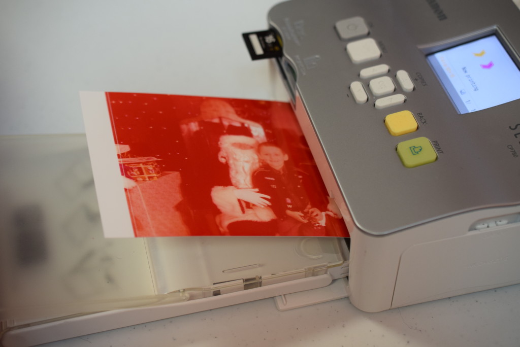 One of Santa's digital pictures gets printed out. The printer makes a few passes to achieve full color, before it is handed out to a child.