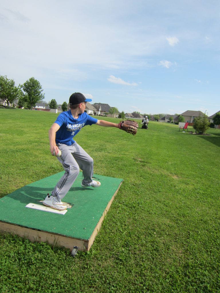 Kade Oliver fires a baseball at his grandfather, Bob Gillum, 60 feet away in his wheelchair.