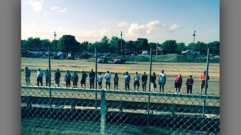 Torch Bearers line up on the track in front of the grandstand as they are introduced. Photo by: Nancy Carlson