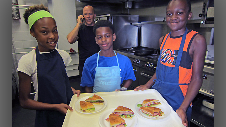 Members of Team Guac show off their sandwiches. Photo by: John Carlson