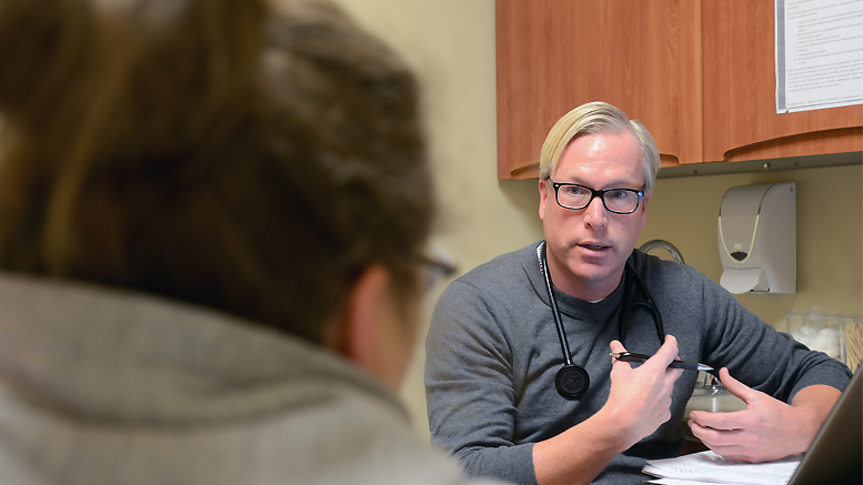 A patient is evaluated by a local physician. File photo.