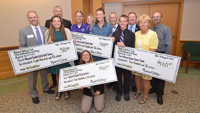 Members of the Muncie Rotary Club are pictured with Muncie Community Schools sports team members with their checks. Photo by: Mike Rhodes