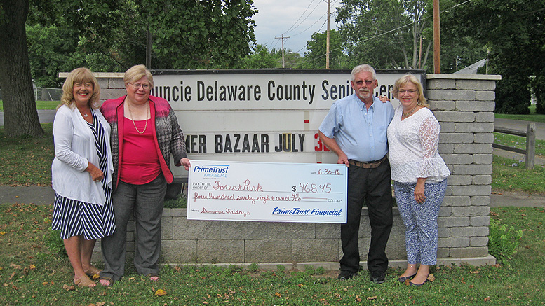 PrimeTrust representatives present Forest Park with a check from their Summer Fridays fundraiser. Photo provided.