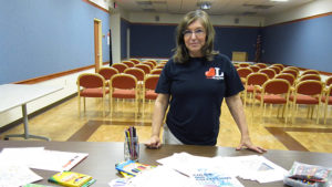 Mary Lou Gentis sets up supplies for "Color Me Calm," an adult coloring program. Photo by: Raven Brooks