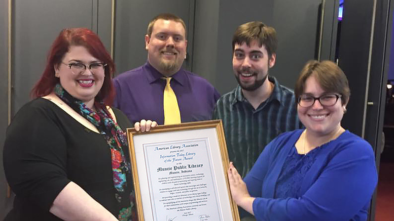 From left to right: MPL employees Rebecca Parker, Dan Allen, and Stuart Cotton pose with Brandi Scardilli, award presenter and an editor at Information Today, Inc. Photo by: Mary Lou Gentis, Muncie Public Library