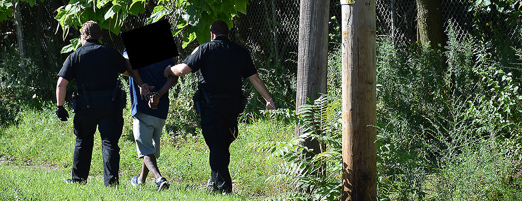An alleged hit and run suspect is apprehended moments after fleeing the scene of a car accident. Photo by: Mike Rhodes