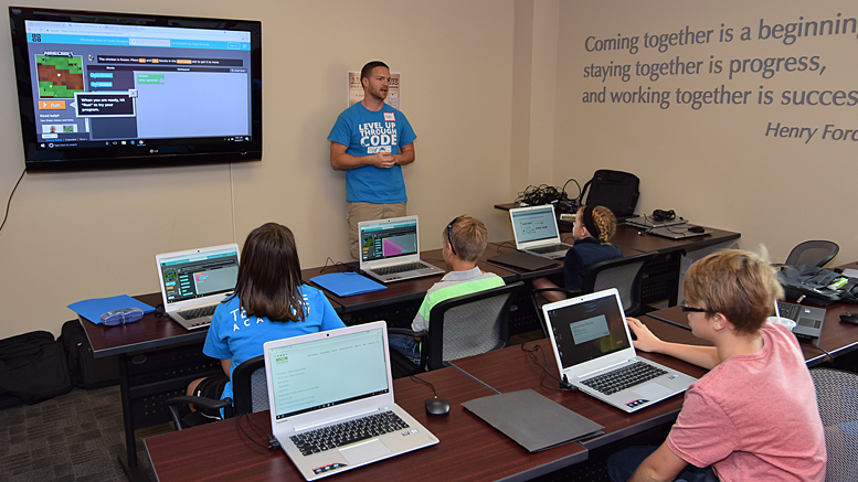 Ryan Hunter presents to students at the the Coding Connector's "Day of Code Foundations 1 & 2" held on Saturday, August 26th. Photo by: Mike Rhodes