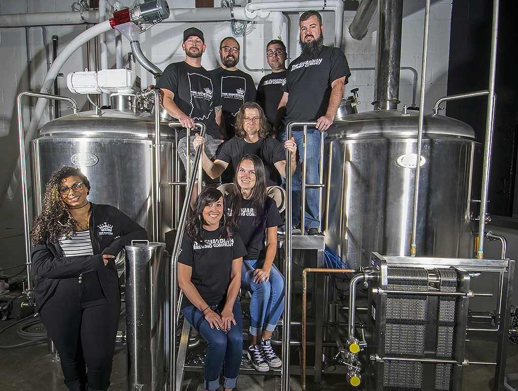 Pictured standing on the 15 barrel brew house—Men: (Top Row L-R)—Bill Kerr, Kyle Johnson, Sean Fickle, Jarrod Case, Jason Phillips. Women: (L-R) Felix Buck, Talia Schroeder, Jennifer Chrich. Photo by: Mike Rhodes