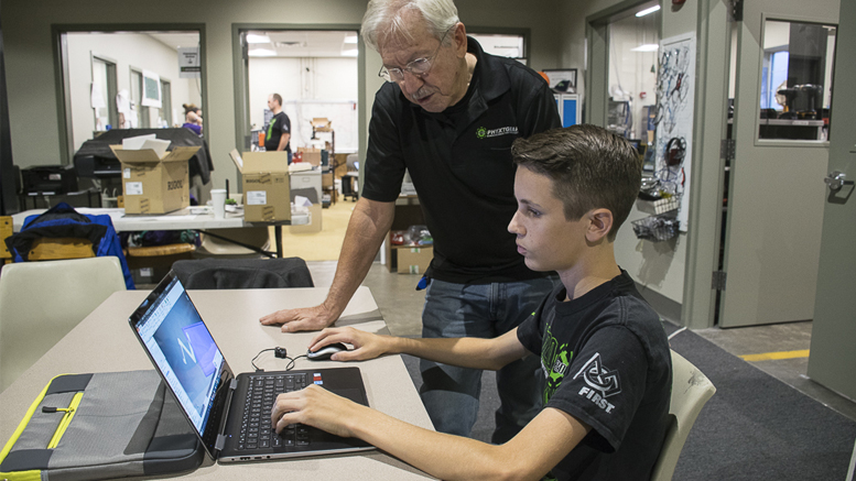 Mike Koch, PhyxtGears vice president and mentor. Caleb is working on a CAD drawing animation for a wire filament extension from the satellite. (See his CAD video at bottom of story.) Photo by: Mike Rhodes