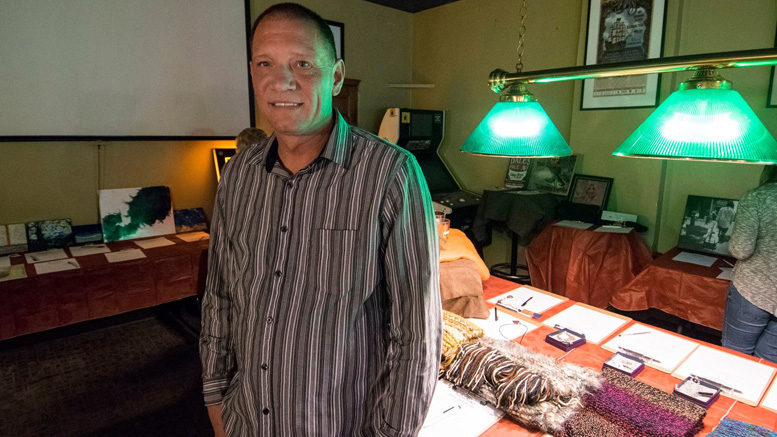 Derek Hilbert is pictured in front of items donated for "Tips for Turkeys" at the Fickle Peach. Photo by: Mike Rhodes