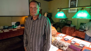 Derek Hilbert is pictured in front of items donated for "Tips for Turkeys" at the Fickle Peach. Photo by: Mike Rhodes