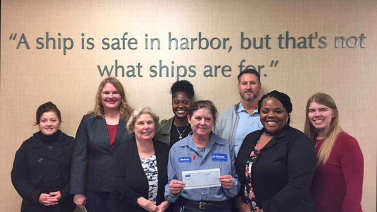 Photo (left to right): Kimberly Gruesbeck, Sana Szewczyk, Zenee Gadson, Elizabeth Covington (presenting the check), Simon Martin. Representing Second Harvest are: Karen McTague, Dorica Watson and Alex Sheward.