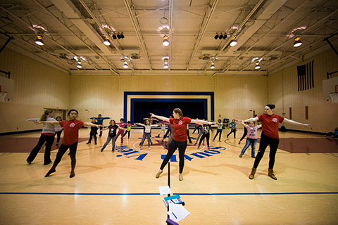 Adrian Alora, Alexandria Koontz and Brienne Mudrack, Ball State students involved in the "DANCE! Muncie After-School" immersive learning project at Ball State, lead a group of about 20 students at South View Elementary School in a dance exercise. The Ball State students create their own lesson plans each week to introduce new dance principles and choreography to the elementary students. Photo provided.