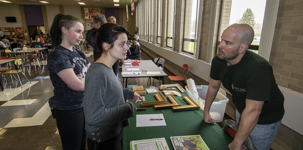 (L-R) Alisha Partain and Anna Williams are pictured talking with Seth Davidson, Assistant Director of Admissions at Ivy Tech.