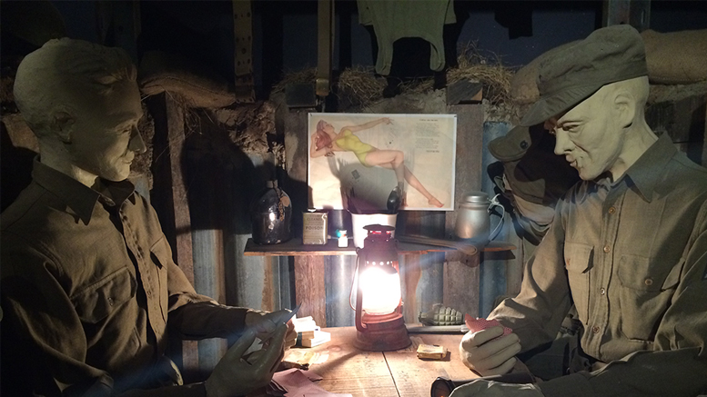 Ernie Pyle and a GI play cards in this recreated dugout scene. Photo by: Nancy Carlson