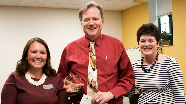 John Marsh, a history teacher at the Indiana Academy for Science, Mathematics, and Humanities, has been named the recipient of the inaugural Robert P. Bell Creative Teaching Award from The Community Foundation of Muncie and Delaware County. John (center) poses with Foundation program officer, Carly Acree-King (left), and president, Kelly K. Shrock (right). Photo by Mallory Huxford.