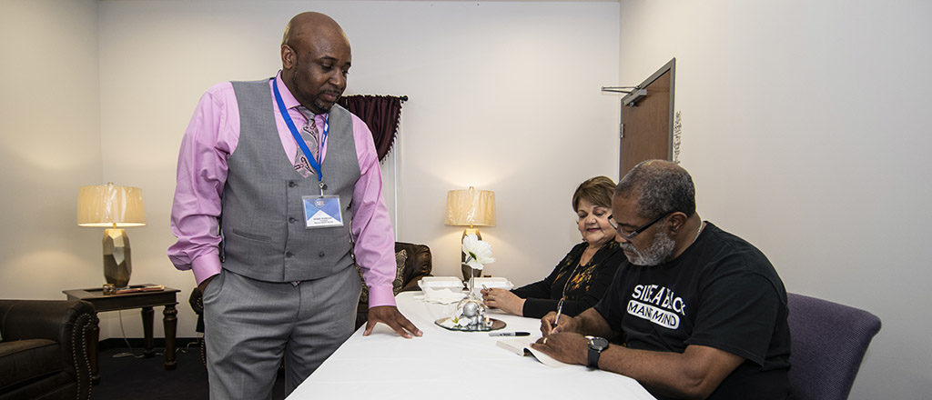 Ron Stallworth and his wife Patsy are pictured as Ron signs a copy of his book "BlacKkKlansman" for Joseph Anderson, president of the Muncie NAACP branch. The book signing was held at Ron's book was turned into a Spike Lee film of the same name. The inscription Ron wrote was, "To my brother from another mother."