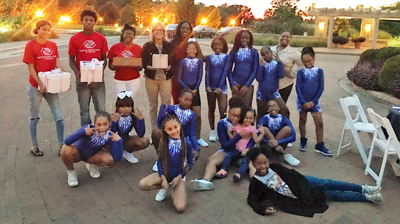 Heidi Hale and dancers from the Boys & Girls Clubs of Muncie's dance team pause for a picture before digging into the cake they won. Photo provided