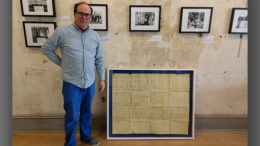 Mark Perretta stands beside the 40"x50" mount and frame he crafted surrounding lyrics handwritten by Roger Waters of Pink Floyd. Photo provided