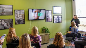 Attendees at today's press conference watch a brief video. Photo by: Zach Poor