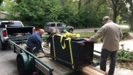 Shannon (left to right), William and Chris load up the safe. Photo by: Nancy Carlson