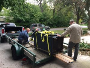 Shannon (left to right), William and Chris load up the safe. Photo by: Nancy Carlson