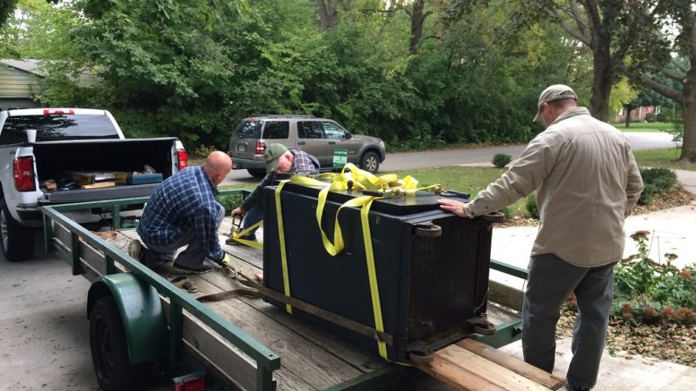 Shannon (left to right), William and Chris load up the safe. Photo by: Nancy Carlson