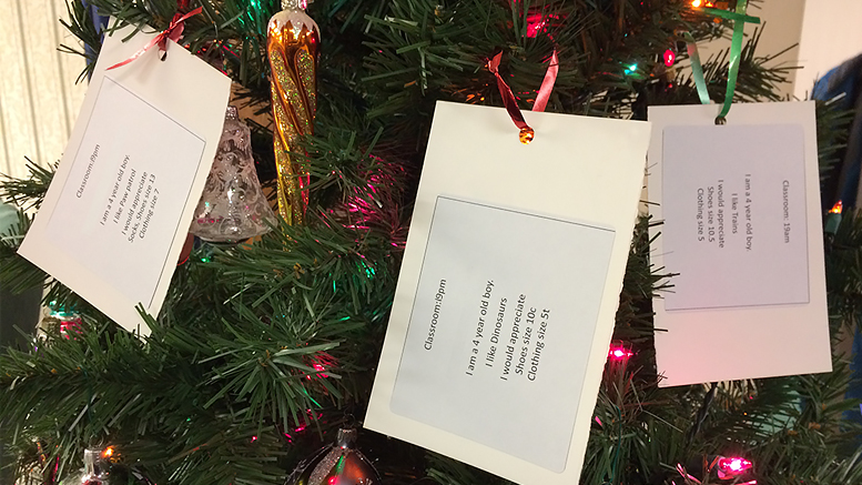 Local kids’ Christmas wishes in cards tied to trees. Photo by: Nancy Carlson