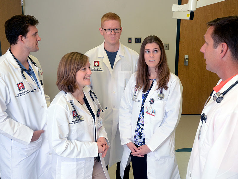 Family medicine residents at the IU Health Ball Family Medicine Residency listen as Christian Shue, DO, explains a procedure.