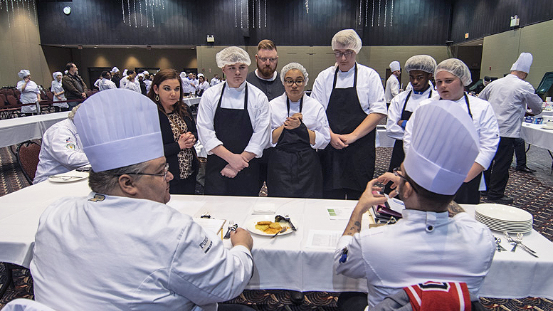 Chef judges provide feedback to students about their entry during the culinary STAR event. Photo by: Mike Rhodes