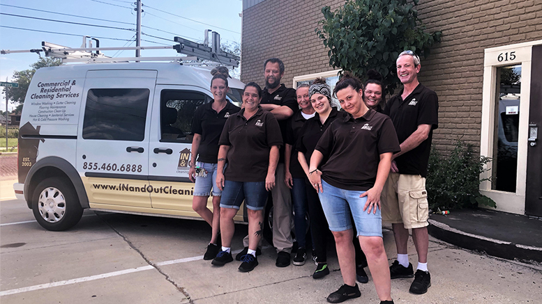 Employees of In & Out Cleaning Services are pictured outside their building. Photo provided by: Alex Romoser