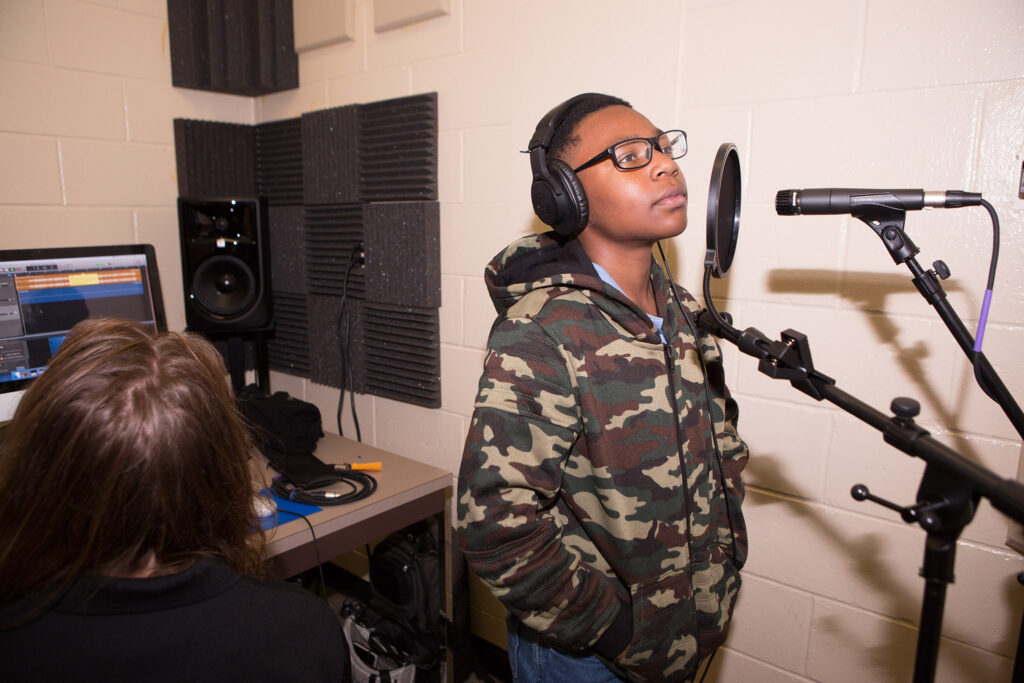 Middle schooler Justin gets ready to record his rap lyrics in the studio. Photo provided